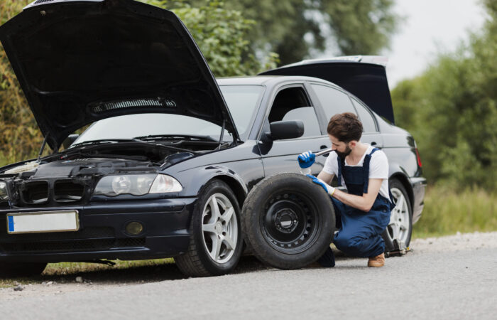 long-shot-man-swapping-tire